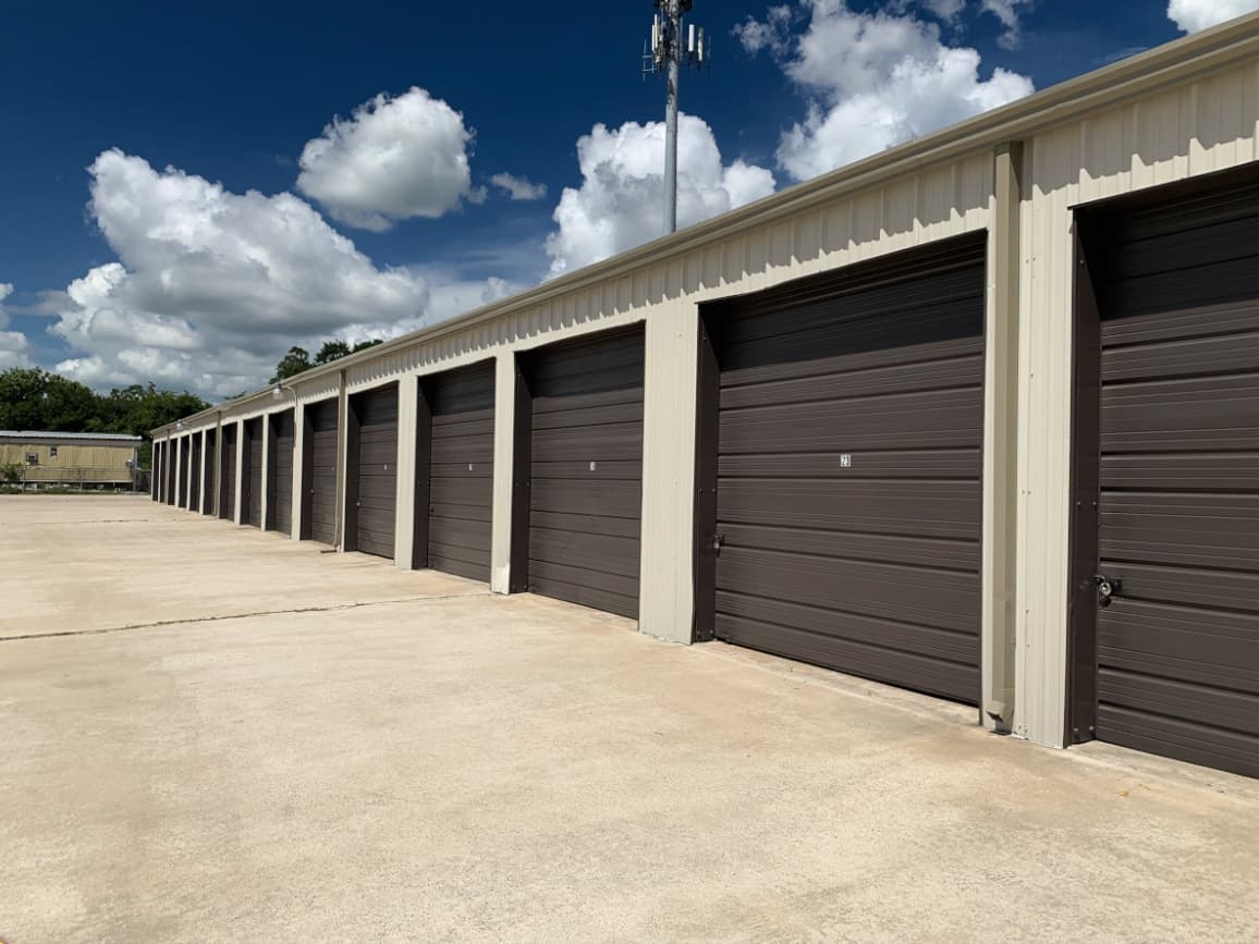 Same Houston storage facility with freshly repainted roll-up doors and crisp trim after commercial painting