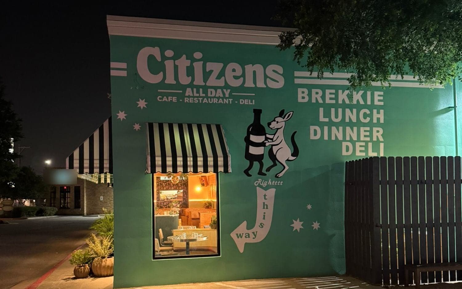 Side wall with Citizens lettering, a painted kangaroo hugging a bottle, stars and Brekkie Lunch Dinner Deli lettering