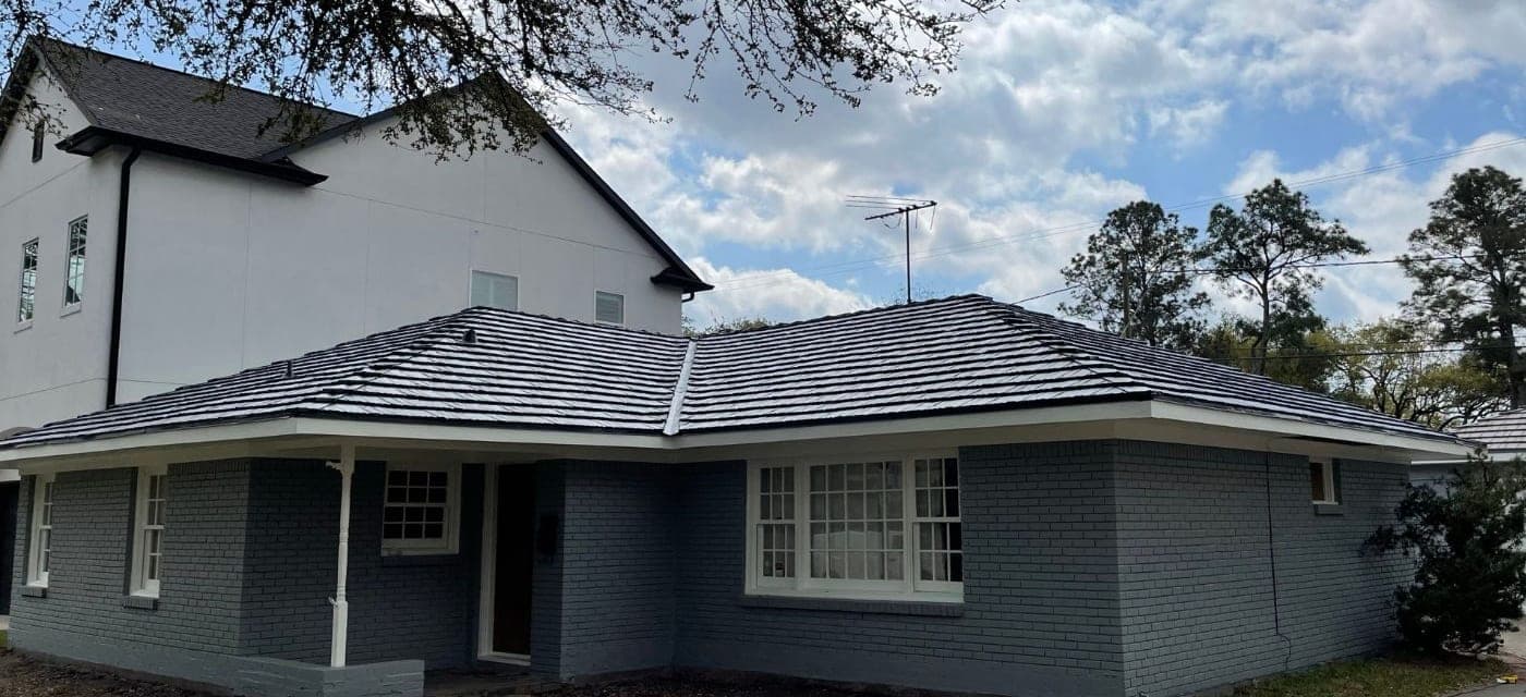 Bellaire ranch home with gray painted brick walls, white trim and white divided-light windows