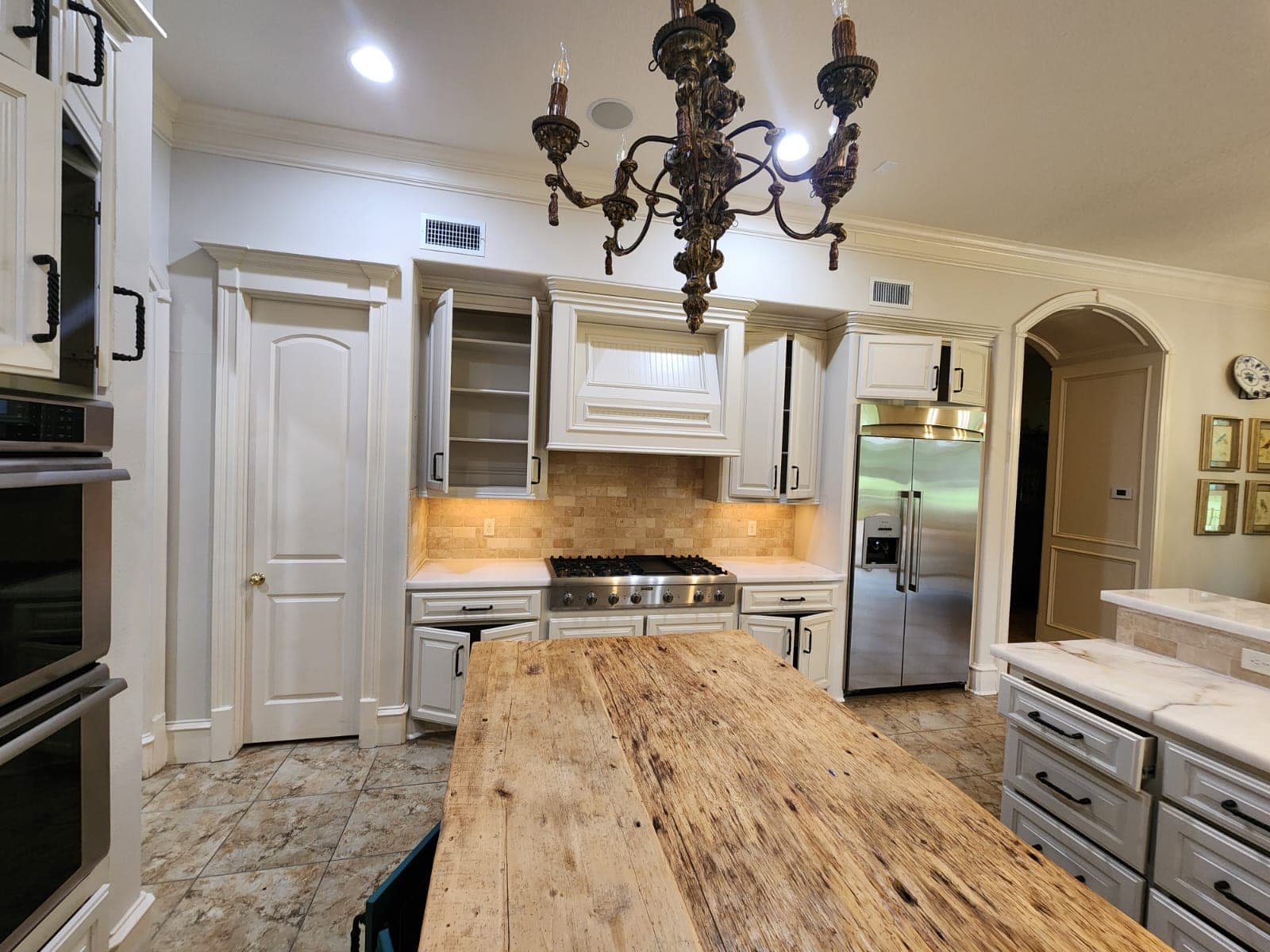 White cabinets and a white wood range hood with beadboard detail around the cooktop