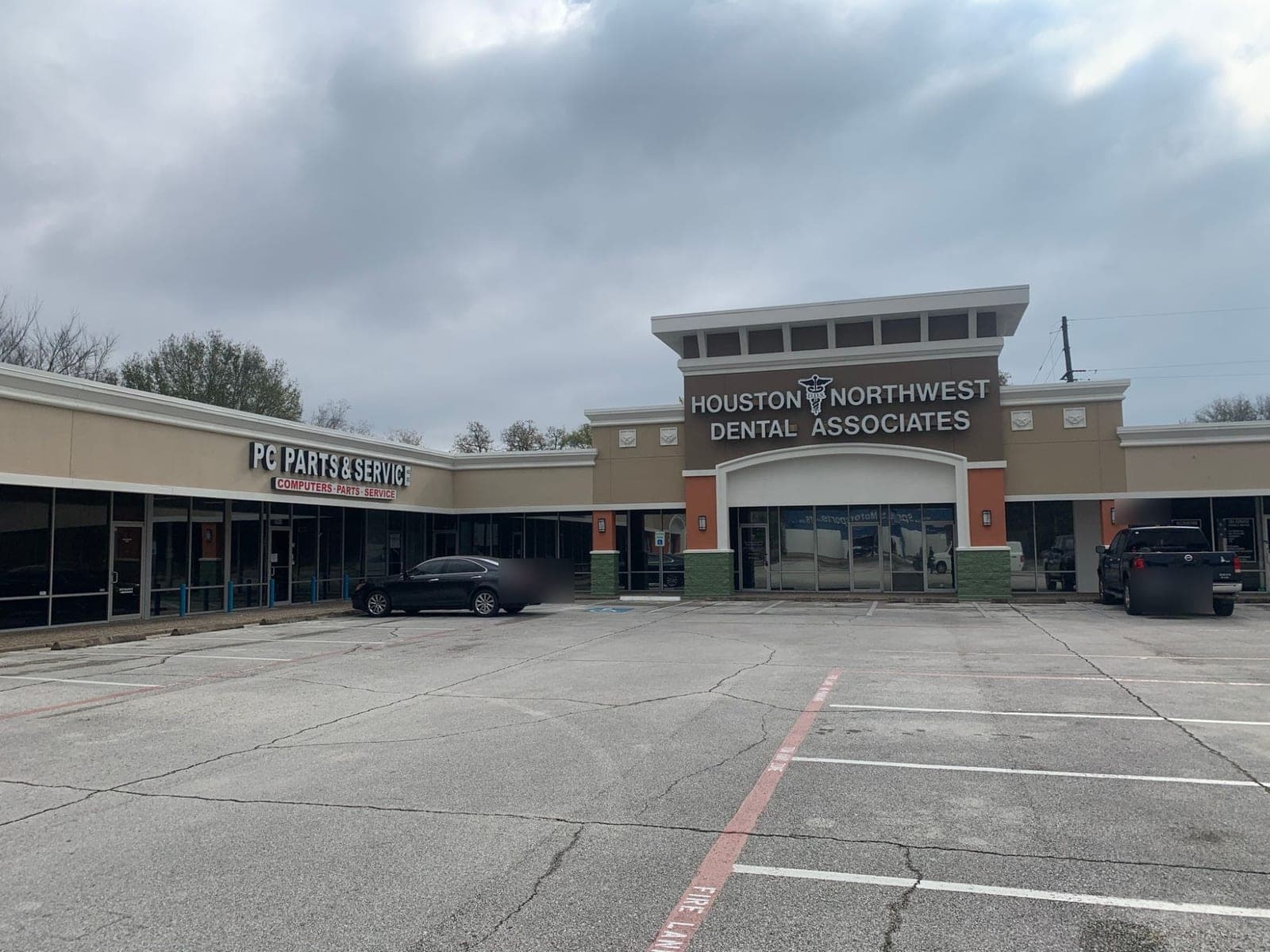 Overview of the retail center wings with tan stucco and white trim