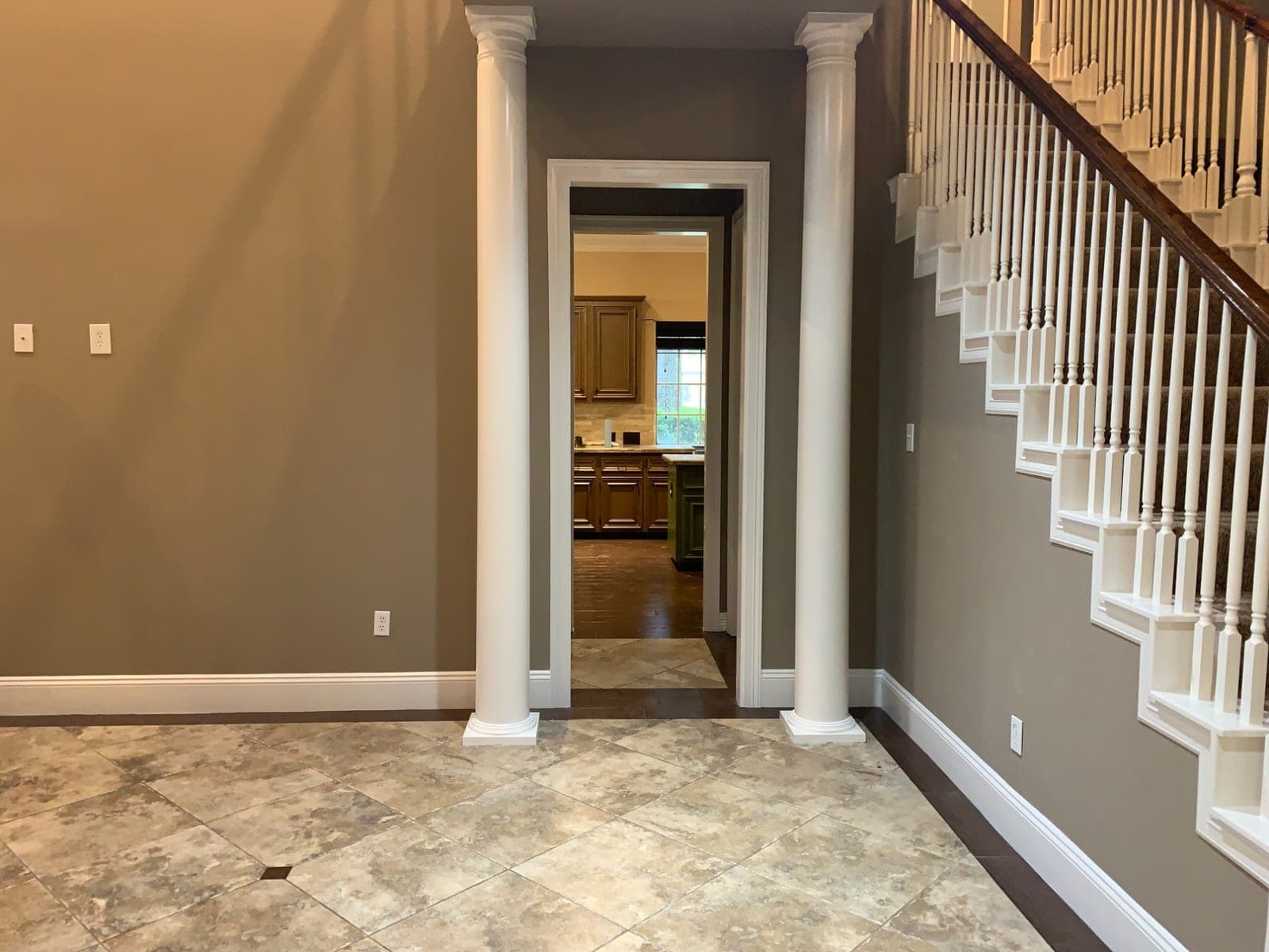 White columns, door casing and stair skirt in a Richmond foyer