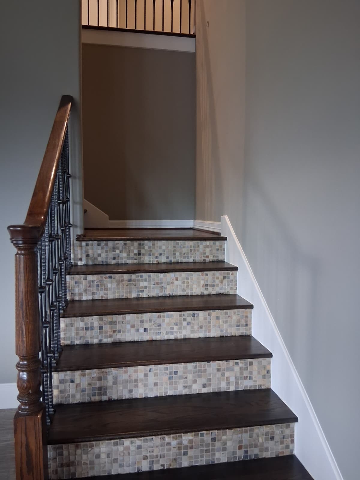 Staircase with white stair skirt board and greige walls