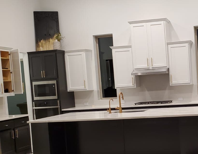 Richmond kitchen with white shaker upper cabinets, near-black lower and tall cabinets, and a dark island